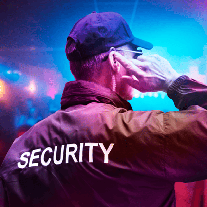 Licensed security guard using a radio at an event in Seattle CBD