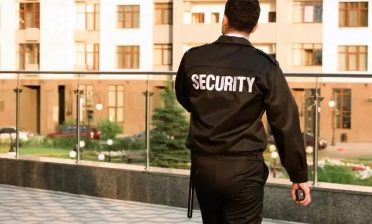 Professional building security guard monitoring a residential property in Seattle
